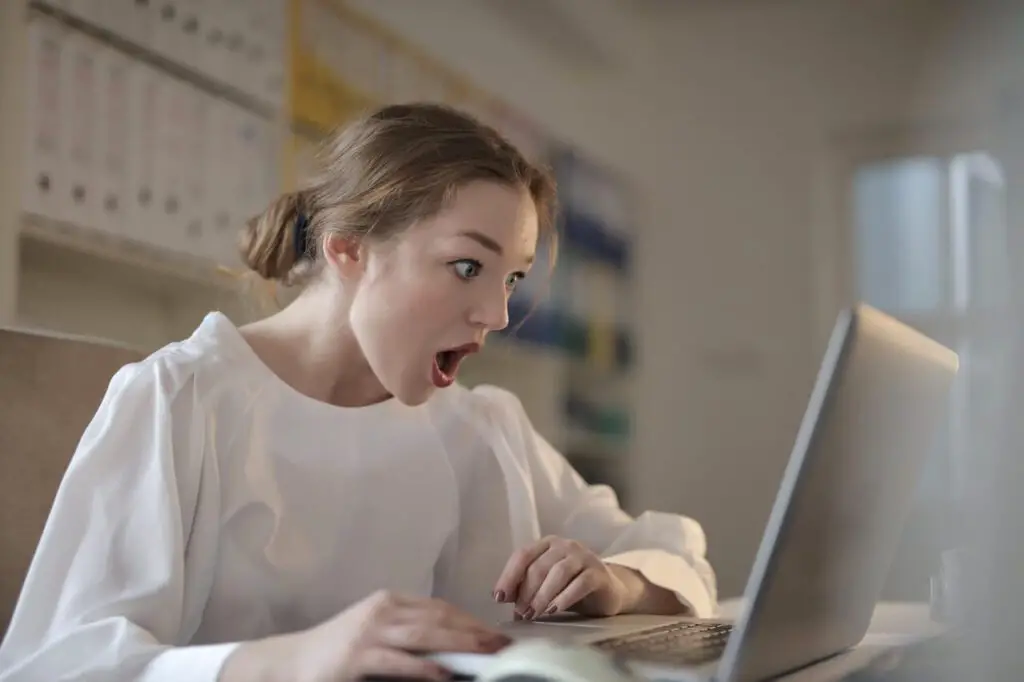 surprised woman staring at laptop