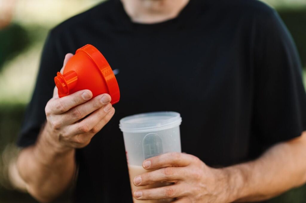 guy holding protein shake