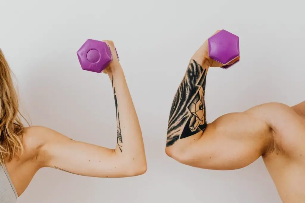 a woman and a man holding dumbells