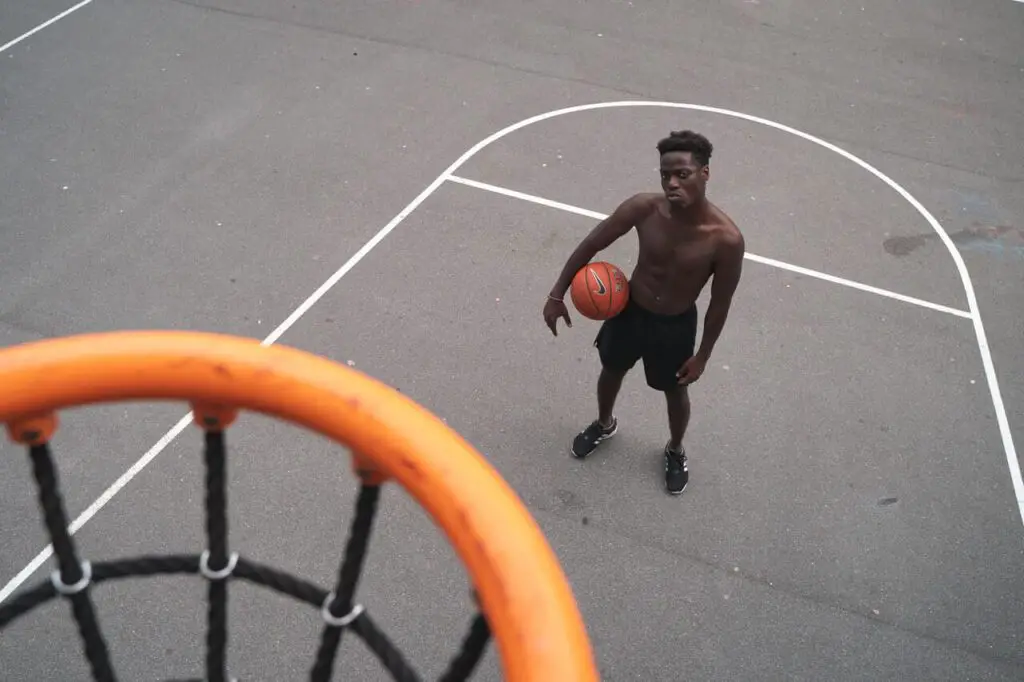 man standing near basketball hoop