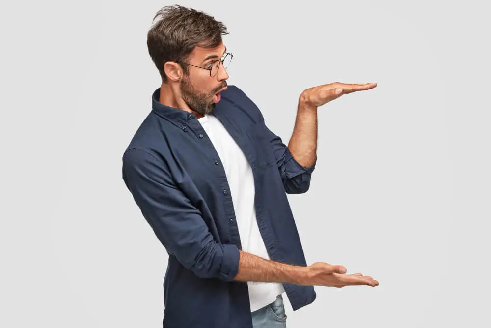 shocked guy gestures height with hands