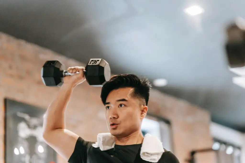 man doing shoulder press in the gym