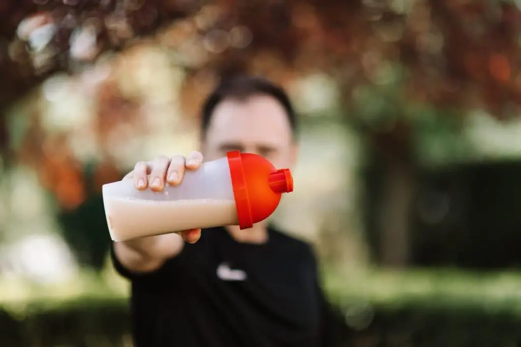 man holding protein shake