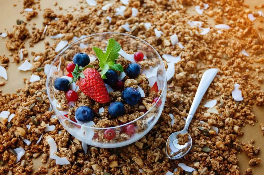 bowl of strawberry above table full of oats