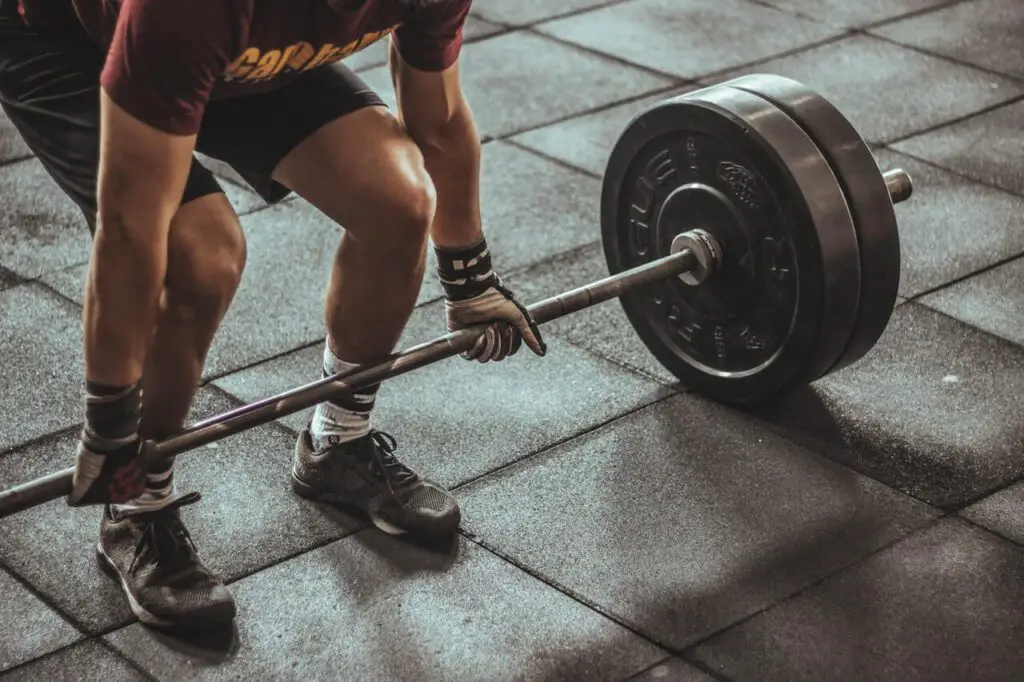 best activities for ectomorphs: person holding barbell