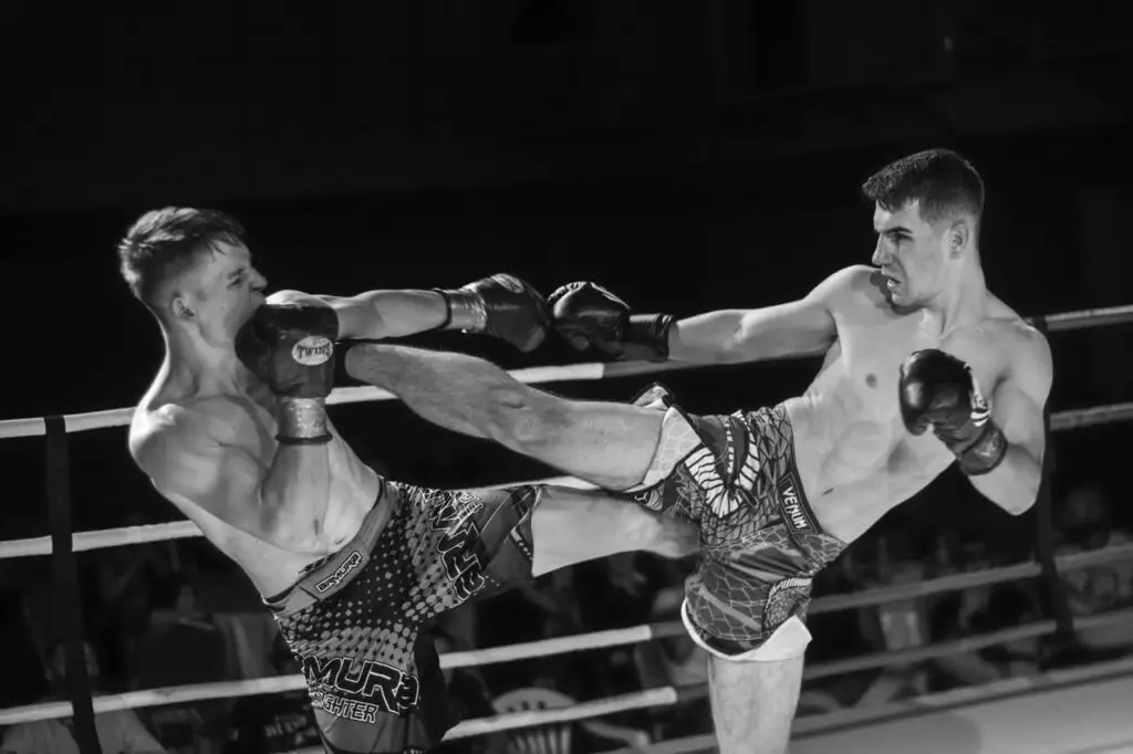 men fighting in the ring