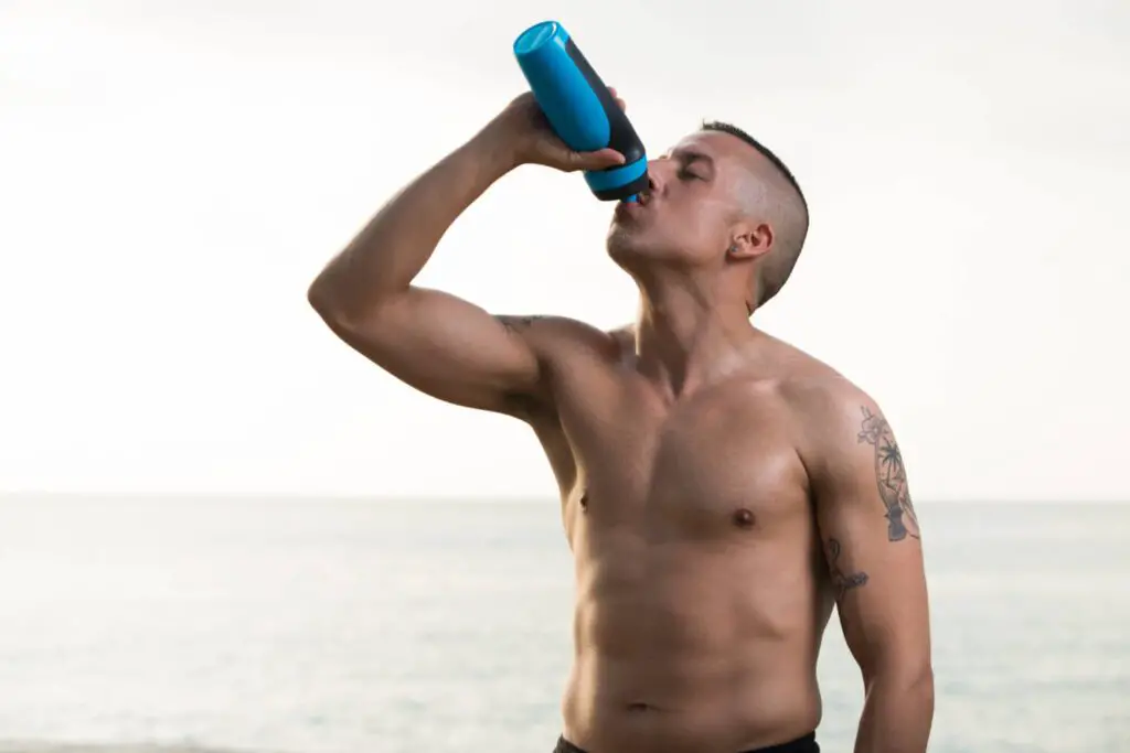 Fit man drinking protein from shaker