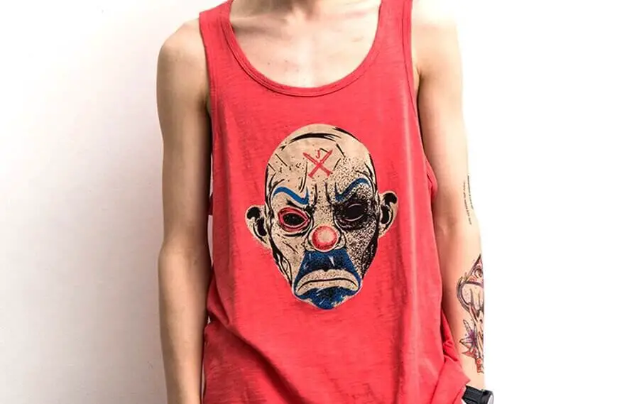 skinny man wearing red tank top with graphic