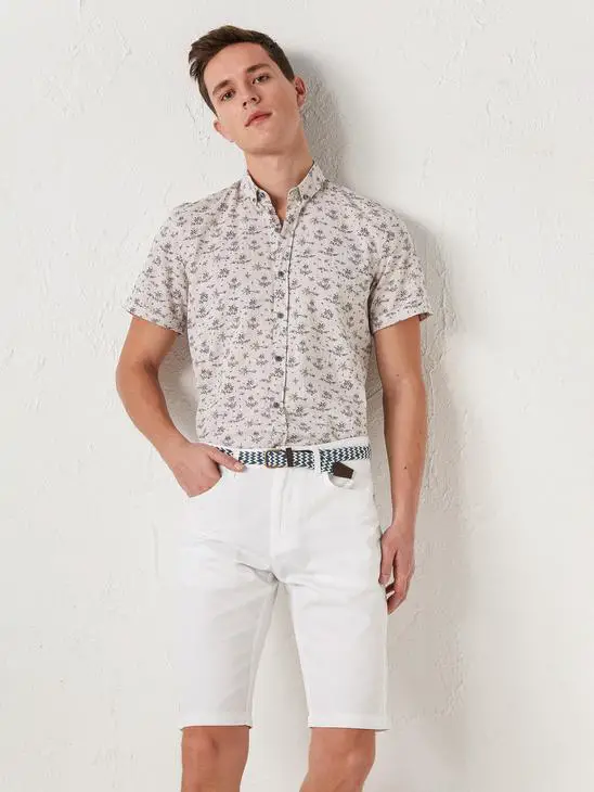 skinny guy wearing floral shirt and white shorts