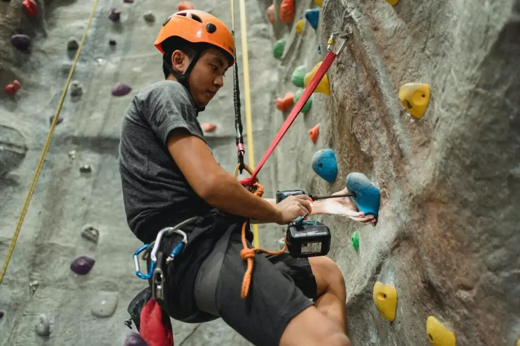 skinny guy rock climbing