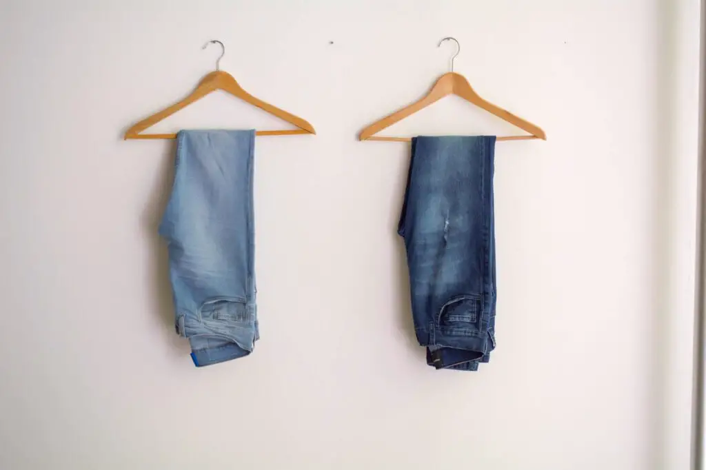 two hanged jeans on a wall