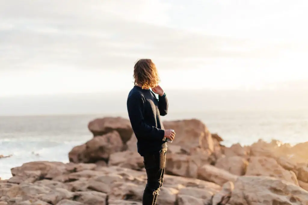 skinny guy standing far away from camera