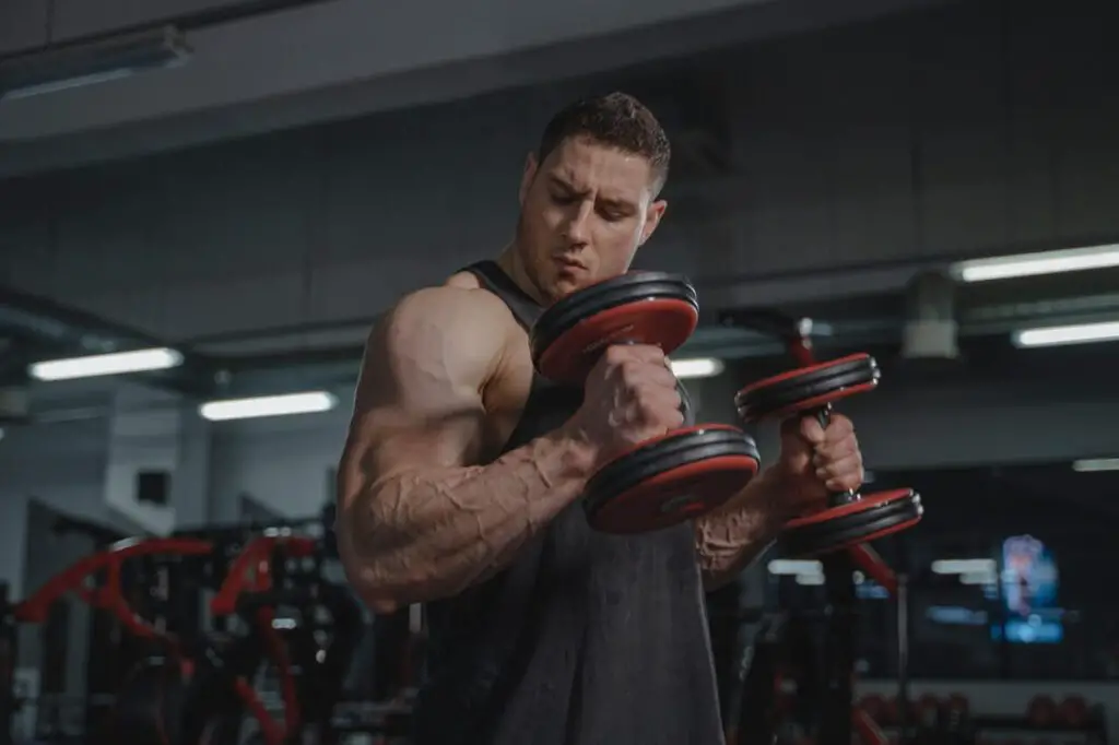 buff guy lifting dumbells